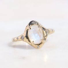 This celestial-inspired piece captures the essence of the goddess of the moon. With its moonstone centerpiece and delicate diamond accents, it carries the serene, otherworldly aura of the night sky. As an engagement ring, it symbolizes the eternal journey of love, akin to the moon's unending phases. Embrace the cosmic sentiment and make it a cherished part of your unique love story. 8x6 mm moonstone, two star set 1.5mm diamonds on each side of the stone, two 1mm diamonds above and below the ston Astronomy Engagement Ring, Moonstone And Diamond Ring, Cosmic Engagement Ring, Moon Stone Ring Engagement, Moon Stone Engagement Ring, Moon Wedding Ring, Celestial Engagement Ring, Moonstone Engagement Rings, Star Engagement Ring