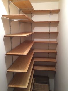 an empty closet with shelves and bins