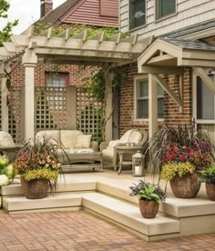 an outdoor living area with seating and flowers