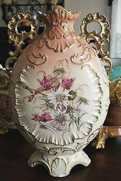 an ornate vase sitting on top of a wooden table