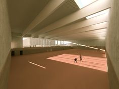 two people are walking in an empty room with red flooring and white columns on the ceiling