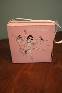 a pink box sitting on top of a wooden table