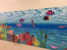 this is a painting on the wall of a school room with fish and corals