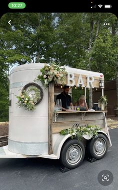 a food cart with flowers and greenery on it