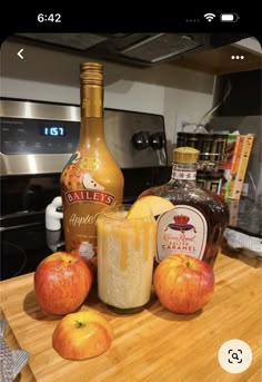 an apple cider and some oranges on a counter