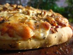 a close up view of a pizza with cheese and toppings on it's crust