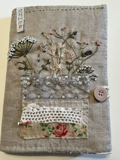 a piece of fabric with flowers on it and buttons attached to the side of it