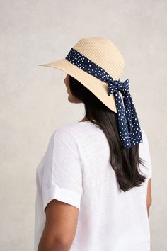 This summer accessory is fashion made easy, bringing a Parisian touch to a classic sunhat design with a polka dotted ribbon in navy and white. Perfect for your next outdoor event or beachside holiday, this sunhat with a subtle gold metallic weave, is crafted from polypropylene braid and straw in a neutral shade that will easily pair with your everyday looks. Chic Summer Straw Hat Packable, Chic Packable Straw Hat For Summer, Navy Beach Hat, Spring Navy Adjustable Hats, Chic Adjustable Sun Hat With Upf 50+, Navy Hat For Spring, Navy Wide Brim Sun Hat For Summer, Chic Lightweight Adjustable Sun Hat, Navy Visor Hat For Summer