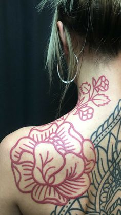 the back of a woman's neck with tattoos on it