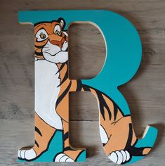 a wooden letter with a cartoon tiger on it