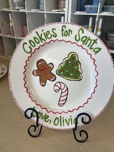 a plate that has some cookies on it with the words cookies for santa and a candy cane