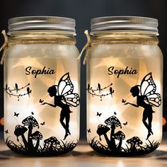 two mason jars with fairy silhouettes on them, one is lit up and the other has