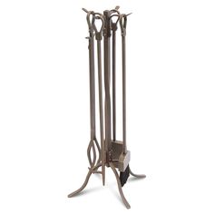 a tall metal fireplace with three candles on it's sides and one candle holder in the middle