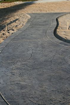 a man riding a skateboard down a cement road