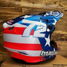 a helmet with an american flag design on it sitting on top of a cardboard box