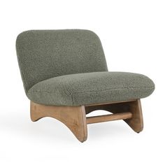 an upholstered chair with a wooden frame and foot rest in the shape of a wave