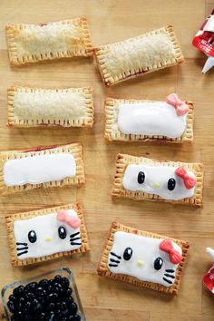 hello kitty crackers are decorated with blueberries and marshmallows to look like cats