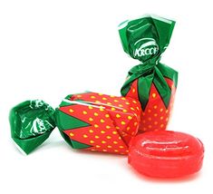 two wrapped candy bags next to each other on a white surface, one with a strawberry design and the other has a green wrapper