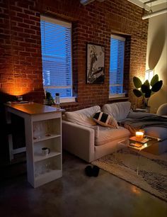 a living room filled with furniture and brick walls