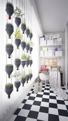 a black and white checkered floor with potted plants hanging on the wall next to it