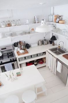 a kitchen with white walls and flooring is shown