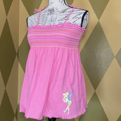 Disney Parks Tinkerbell Warm Weather Short Shirred At Bust/Chest And Flowy Below The Empire Waist Pink With Rainbow Elastic Wavy Stripes Spaghetti Straps With Sewn Bows (Not Adjustable) Tinker Bell Is Blowing Kisses And Has Glittery Wings New With Tags, No Defects Youth Extra Large Fits 59”-64” Tall, 87-115 Lbsequivalent To About A Woman’s Small Sfpf Pink Disney Tops For Summer, Disney Cotton Tops For Spring, Pink Disney Cotton Top, Disney Cotton Tops For Playwear, Pink Cotton Disney Top, Playful Sleeveless Top For Sleepovers, Fitted Sleeveless Tops For Sleepover, Fitted Cotton Tops For Sleepovers, Tropical 2000s