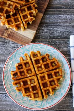 some waffles are on a plate next to a fork