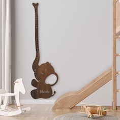 a wooden rocking elephant next to a staircase