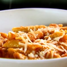 a white bowl filled with pasta and cheese