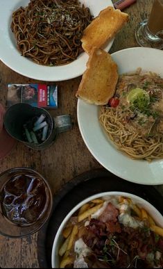 several plates of food on a wooden table