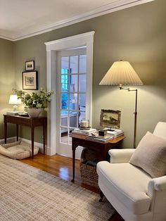 a living room filled with furniture and a lamp