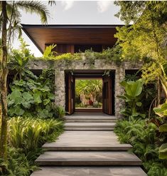 an entrance to a tropical home surrounded by greenery