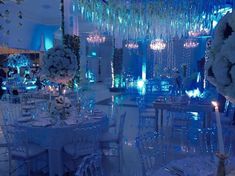 a room filled with tables and chairs covered in chandeliers