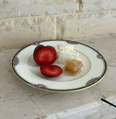 two pieces of fruit on a white plate