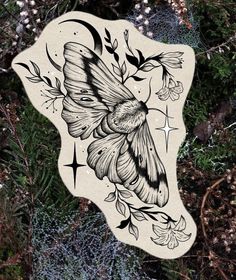 a drawing of a moth on the side of a piece of paper with leaves and flowers