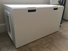 a white refrigerator freezer sitting on top of a tiled floor