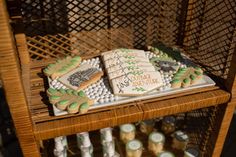 a table with cookies and candles on it that are decorated in green and white icing