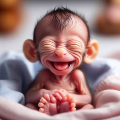 a smiling baby with its mouth open and tongue out in a blue blanket on top of a bed