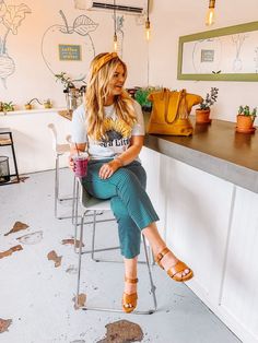 a woman sitting on a chair in front of a counter