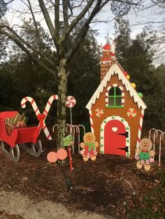 a gingerbread house is decorated with candy canes and candies for the holiday season