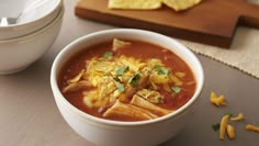 a bowl of soup with tortilla chips on the side