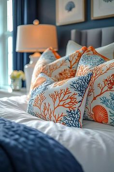 the bed is made with blue and orange pillows