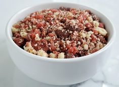 a white bowl filled with food on top of a table