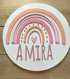 a white sticker with the word amra in pink, orange and yellow on it