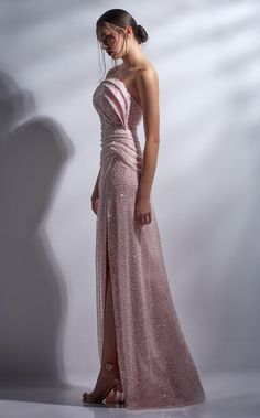 A strapless fitted gown that exudes elegance and glamour. This dazzling dress has a structured top and is made of a mixed sequin and beaded fabric. It has a sli Elegant Evening Dresses Formal Gowns, Glamorous Evening Dresses, Fitted Gown, Mnm Couture, Couture Evening Dress, Straight Across Neckline, Beaded Fabric, Structured Top, Dazzling Dress