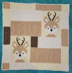 a crocheted blanket with deer heads on it