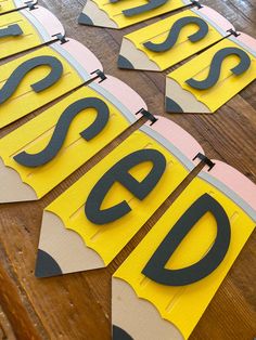 some cut out letters sitting on top of a wooden table