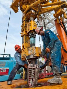 two men are working on an oil rig