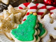 decorated christmas cookies on a plate with candy canes