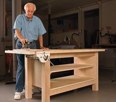 an older man is working on a workbench